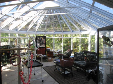 Expansive aluminum conservatory with sliding windows and French doors